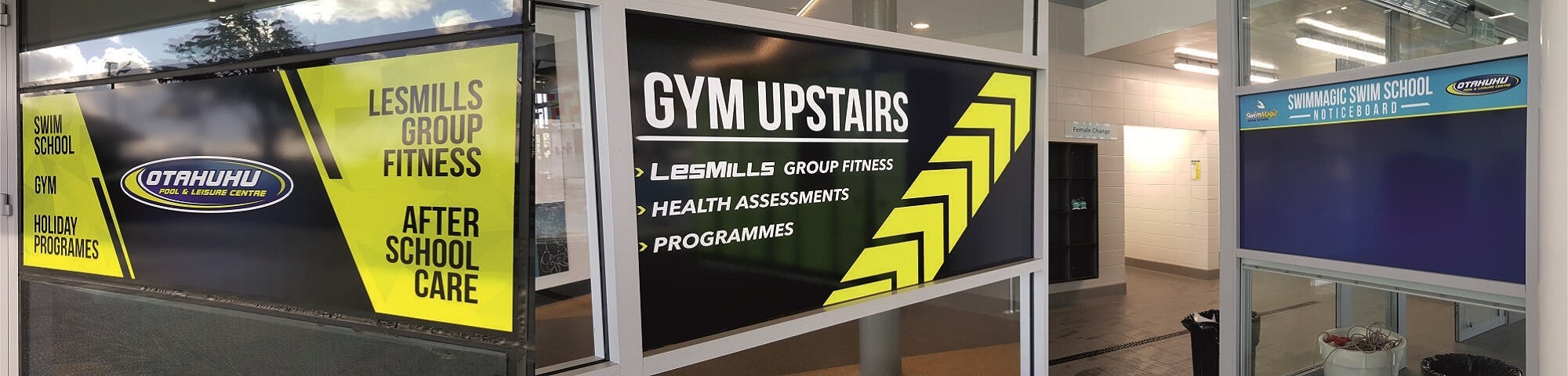 Bold window graphics and wayfinding signage installed by Spot Signz